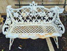 Intricately cast iron garden bench in the Coalbrookdale style, with pierced seat, the back decorated