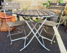 Iron-framed and wooden-slatted top circular garden table, diameter 75cm with two matching folding
