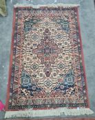 A modern Persian style rug,  pink ground central cartouche in white, green, blue, pink multi border;