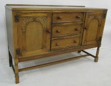 20th century oak sideboard with three drawers flanked by cupboard doors, block supports, 138cm x