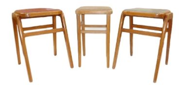Pair of 20th century stools, one with red and the other with grey inset padded tops and another