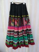 Two flounced skirts labelled 'Maison Clement la Collegiale, St-Paul', one pink with patterned floral