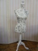 Modern white painted wooden based dress maker's dummy with black and white patterned fabric body