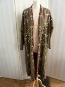 Full-length kaftan-style khaki twill coat, heavily embellished with Indian-style decoration of metal