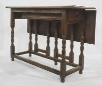 Probably 18th century oak drop-leaf gateleg table having single end drawer with brass handle, on