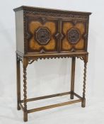 Oak cupboard, the rectangular top above carved and moulded frieze, two doors enclosing shelves, on