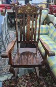 Eastern hardwood rocking chair intricately decorated with brass inlay