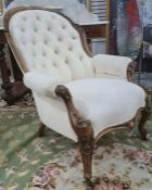 Victorian mahogany framed chair in a cream brown button back upholstery, carved exposed frame to