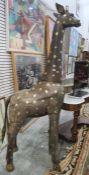 Large wooden model of a giraffe with gilt decoration, in three sections, 199cm high