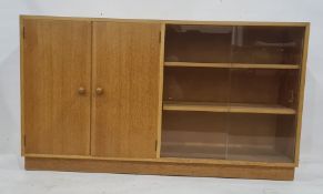 Light oak lounge unit by Meredew Furniture, the rectangular top with two cupboard doors to the