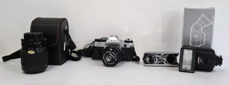 Canon AE1 Programme camera, a Sigma Zoom 1-4/5.6 lens, compact pair of binoculars and one other