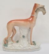 Staffordshire flatback greyhound holding rabbit, 28cm high