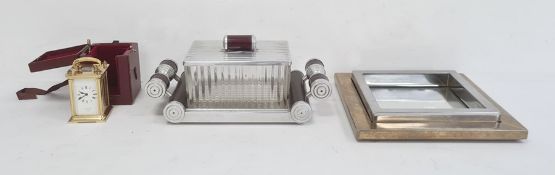 Chrome bakelite and pressed glass cigarette box of Art Deco design on mirrored two handled base, a