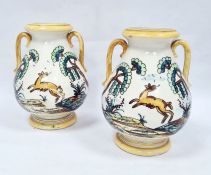 Pair of two-handled pottery vases, probably Italian, decorated with deer and trees within yellow