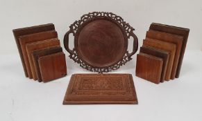 Pair of wooden bookends modelled as books of descending height, a carved wooden two-handled tray and