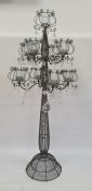 Pair of modern wire candelabra, each with nine glass holders for tealights, supported on scrolling