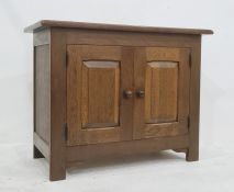 20th century oak two-door cupboard, the rectangular top above two cupboard doors enclosing