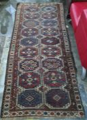 Eastern runner with two rows of nine medallions, in blues, reds and whites, 278cm x 123cm