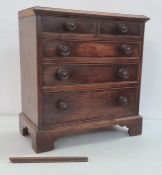 19th century mahogany miniature chest of drawers, the rectangular top with applied moulded edge,