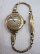 Lady's gold Moba bracelet watch with gilt numerals in circular case, marked 9c, and on rolled gold