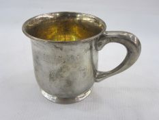 American sterling silver mug of plain form on collet foot with gilt interior, the base inscribed