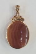 Large 9ct gold double-sided pendant set with red and brown variegated agates, with scroll pendant