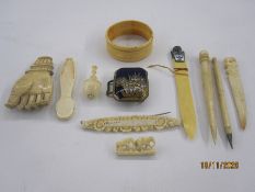 Quantity of antique ivory miniatures to include back scratcher hand, miniature paper knife with