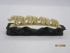 Late 19th/early 20th century carved ivory bridge of four graduated mininature elephants and the