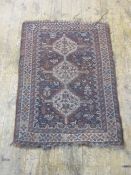 Persian rug with three cream ground central medallions, the brown ground field with assorted animals