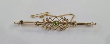 Gold-coloured metal, peridot and seedpearl bar brooch, the central peridot within sprays of small