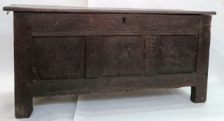 Late 18th/early 19th century oak coffer, the plain top above carved front panels, on stile supports