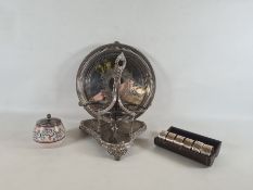 Cased set of six silver plated napkin rings in cylindrical case, wavy engraved decoration with