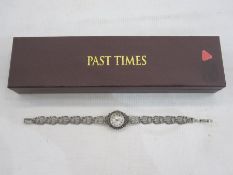 Modern lady's bracelet watch with circular mother-of-pearl dial in marcasite case and on pierced