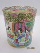 Chinese Canton porcelain tea caddy and cover, cylindrical and painted with figures in a garden, in