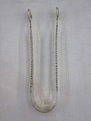 Pair of 18th century silver sugar nips with scalloped ends, pierced handle and engraved decoration