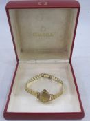 Lady's 9ct gold Omega bracelet watch, the circular dial with baton markers and on textured brick-