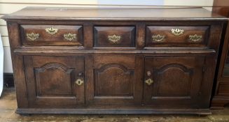 Antique oak sideboard having quadrant mould edge, three frieze drawers each with chamfered edge,