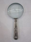 A 1920s silver handled magnifying glass, repoussé decoration to handle, Sheffield 1924, makers