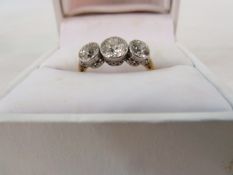 Three-stone yellow gold and diamond ring, the centre stone approx 0.55ct and the stones flanking