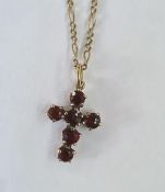 9ct gold and garnet cross pendant on 9ct gold Figaro 24