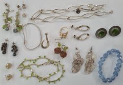 Gold-coloured and aquamarine-coloured stone ring, a silver necklace, silver earrings, beaded