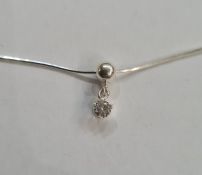 Solitaire diamond drop pendant, claw set, in silver mount, on fine silver chain, the stone