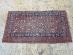 Eastern rug, the red ground field with foliate medallions, with border, 99cm x 174cm