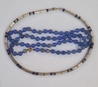 Bead necklace of tubular silver coloured beads interspaced by lapis lazuli beads and a string of