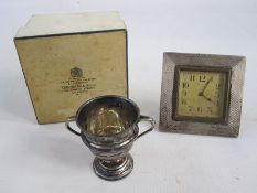 A 1920s silver mounted square framed alarm clock, Arabic numerals to the dial, engine turned