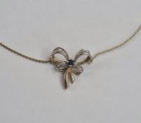 9ct gold diamond sapphire bow pattern necklace, the bow set with small diamonds and single
