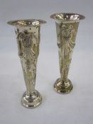 A pair of early 20th century silver weighted trumpet shaped vases, repousse decoration of bows and