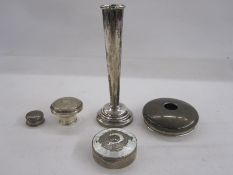 White metal powder box of circular form, unmarked, a silver candlestick and various other items