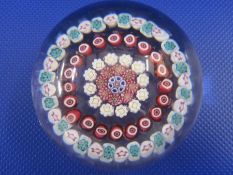 Baccarat paperweight, millefiori decorated with five rings of coloured canes, 6.5cm diameter, with