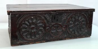 Possibly 16th century oak bible box, the plain rectangular top with carved front featuring two